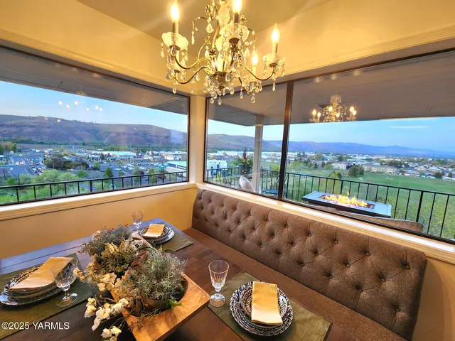 a balcony with wooden floor outdoor seating and city view