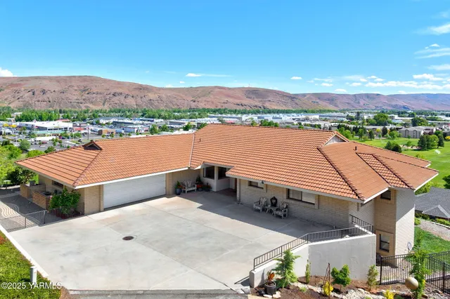 a front view of a house with a yard table and chairs