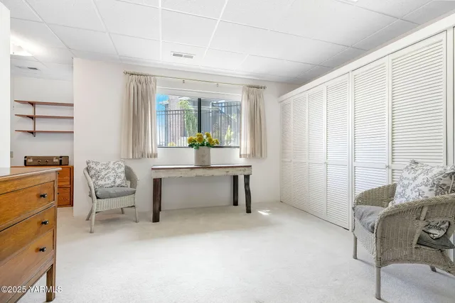 a storage room filled with furniture and a kitchen view