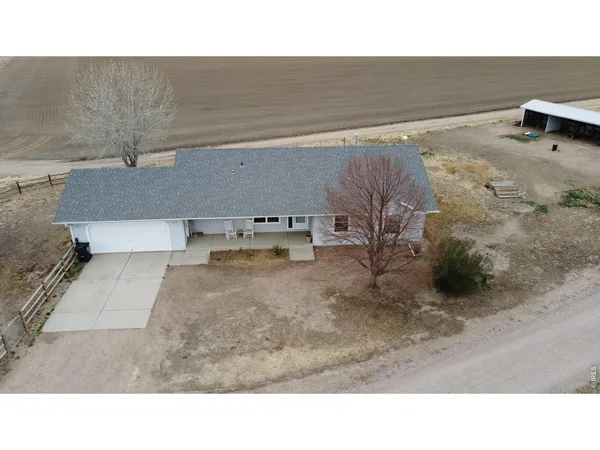 a view of a terrace with lawn chairs