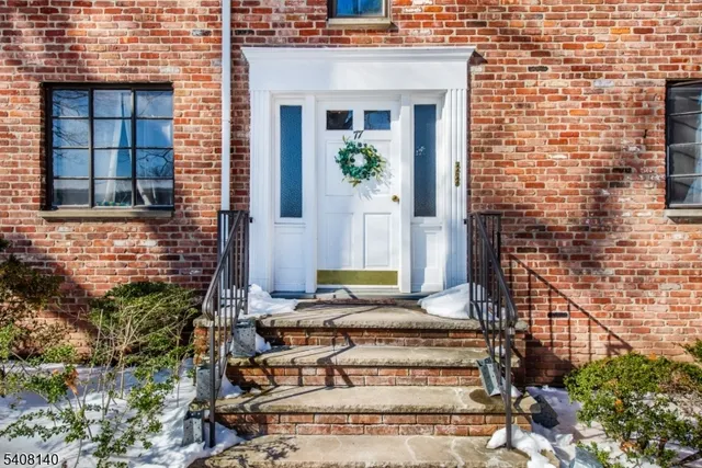 a front view of a house with large windows