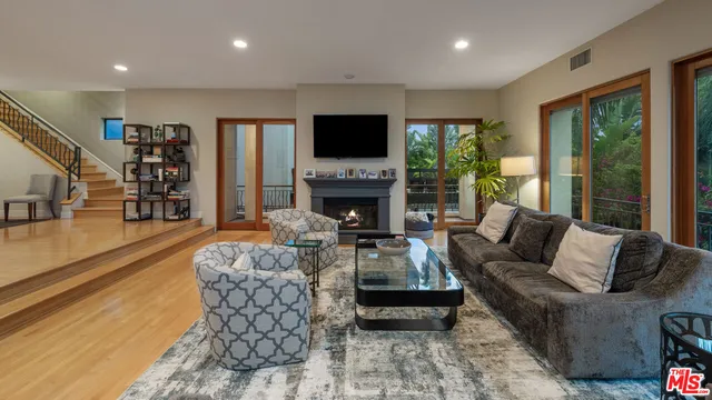 a living room with fireplace furniture and a fireplace