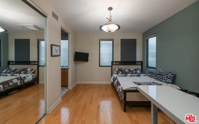 a view of a building with potted plants and a bench