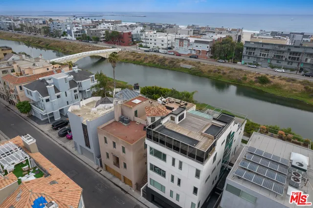 an aerial view of residential houses with city view
