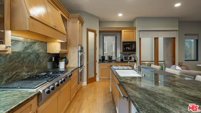 a kitchen with sink a counter top space and living room