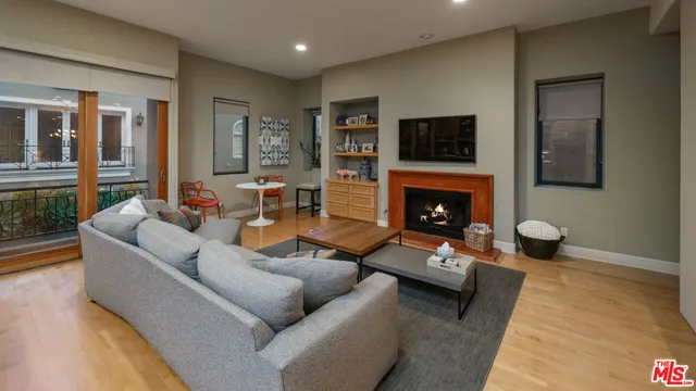 a living room with furniture a rug and kitchen view