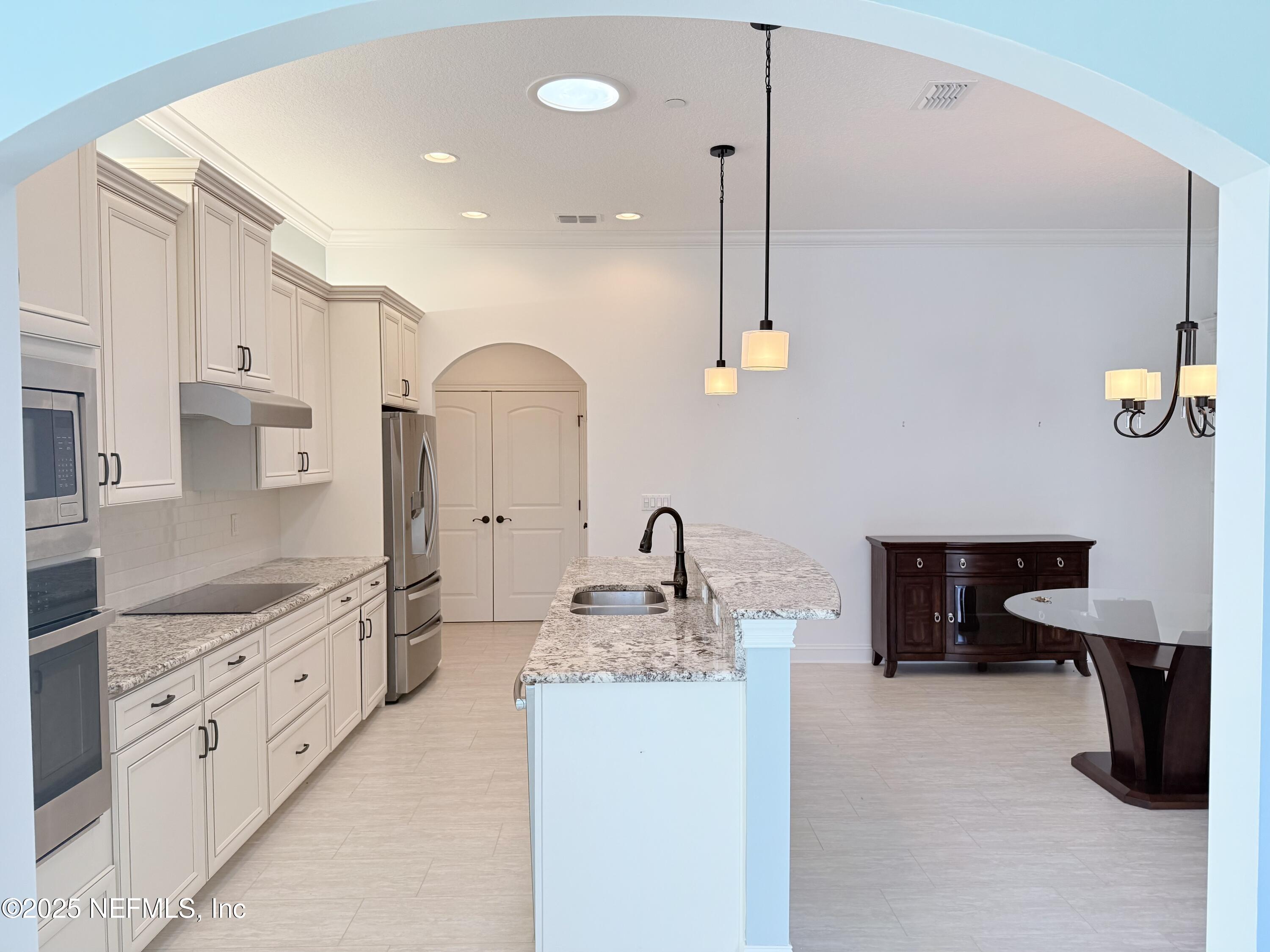 44 Ocale Court St. Augustine, FL 32084 - Photo 13 of 30 a kitchen with kitchen island granite countertop a sink a stove and refrigerator
