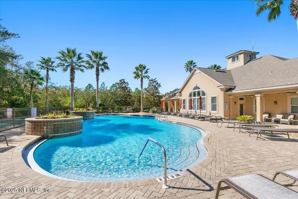 a view of a house with swimming pool and sitting area