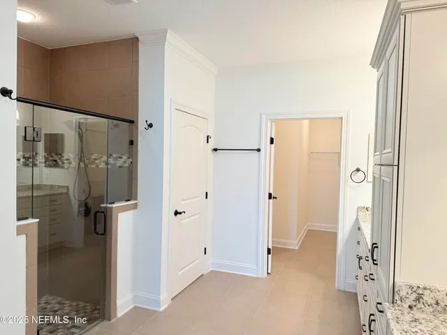 a view of a bathroom with a shower and a sink