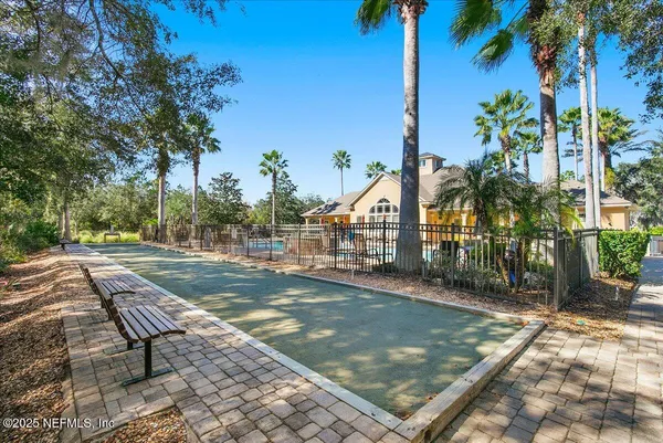 a view of a street with a houses in the background