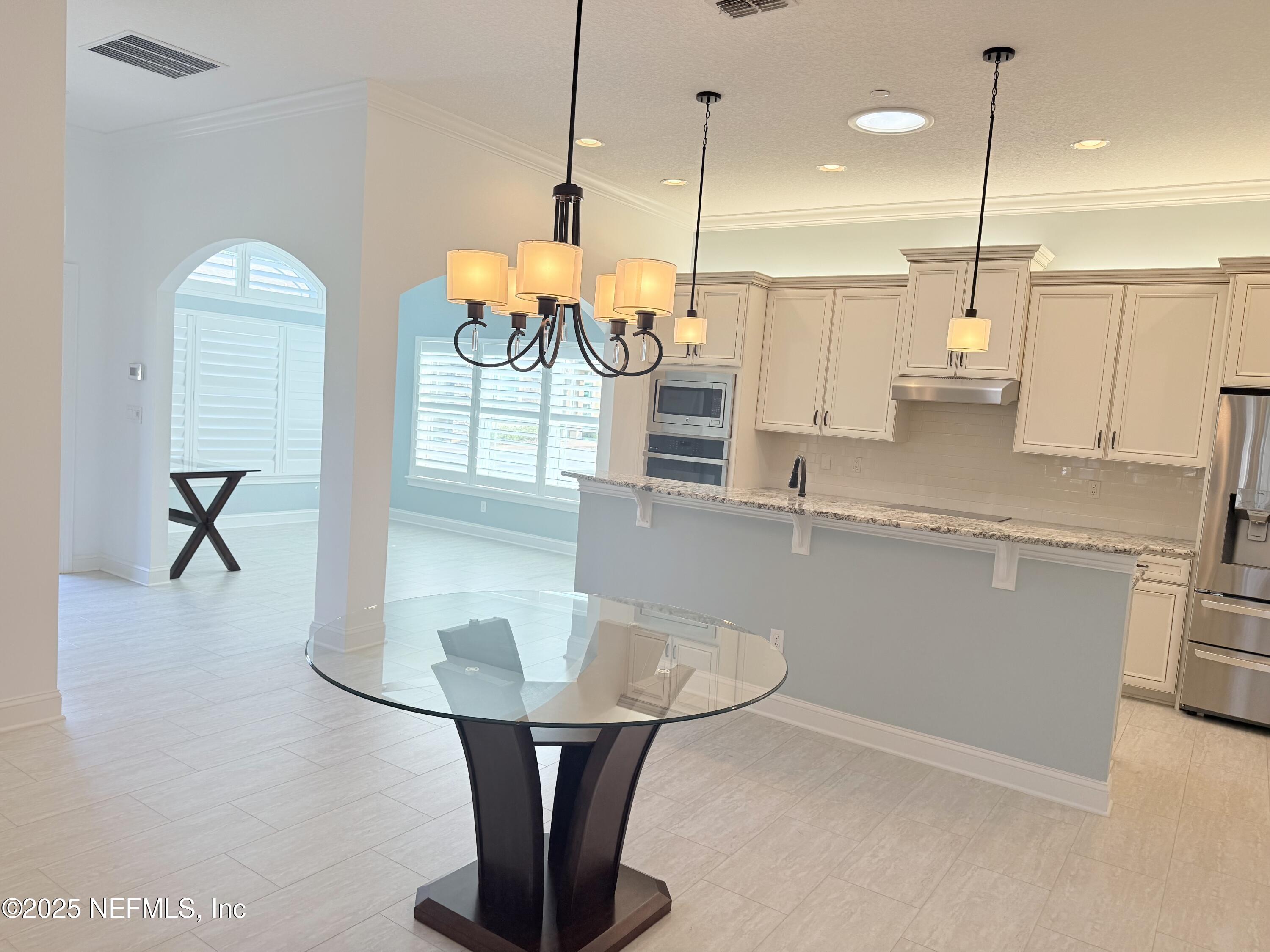 44 Ocale Court St. Augustine, FL 32084 - Photo 10 of 30 a kitchen with stainless steel appliances granite countertop a sink a counter space and a view of living room