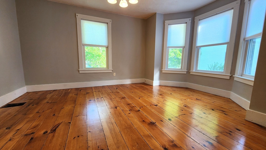 8 Fay Street, Unit 2 Westborough, MA 01581 - Photo 5 of 15 a view of an empty room with wooden floor and a window