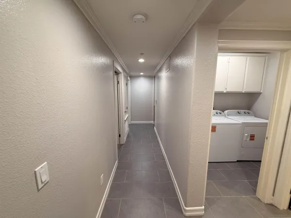 a view of a hallway with washer and dryer