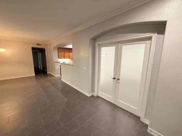 a view of a livingroom with an empty space and a window