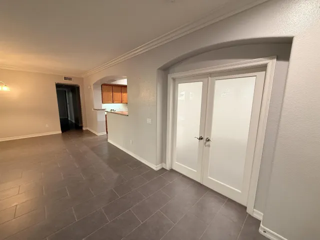a view of a livingroom with an empty space and a window