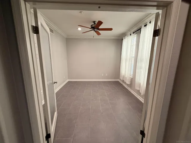 a view of a livingroom with a ceiling fan and window