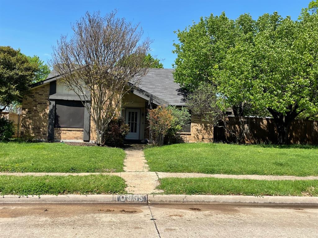 10955 McCree Road Dallas, TX 75238 - Photo 1 of 1 a front view of a house with a yard and garage