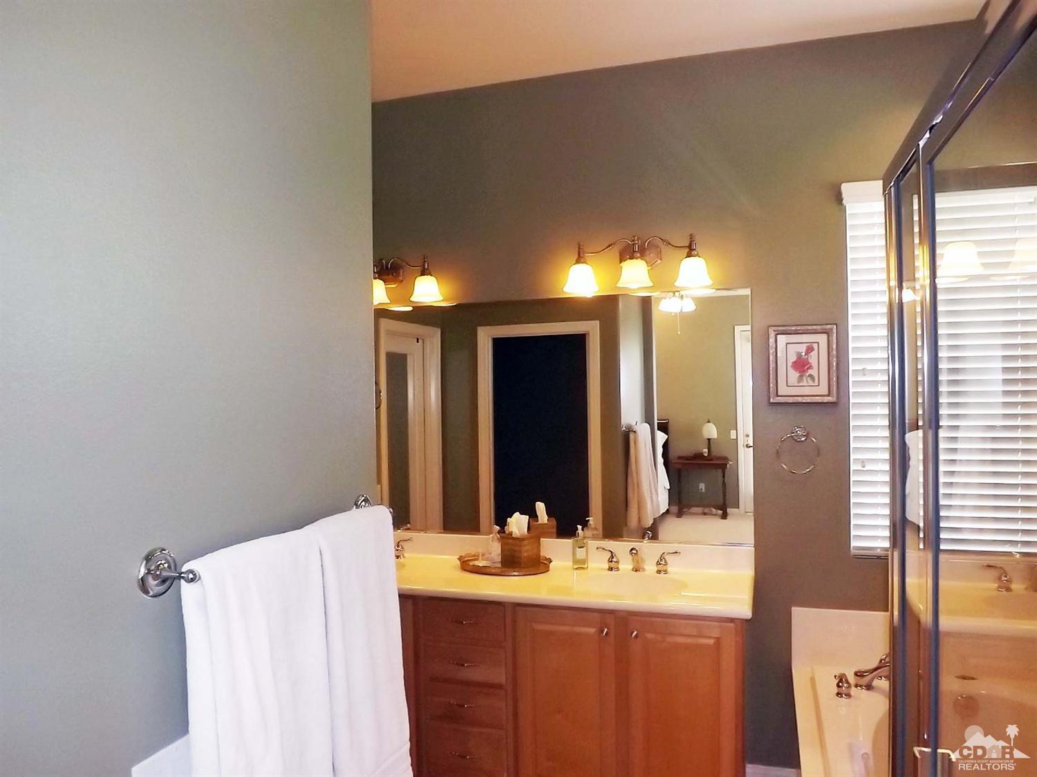 80540 Knightswood Road Indio, CA 92201 - Photo 15 of 34 a bathroom with a double vanity sink and a mirror