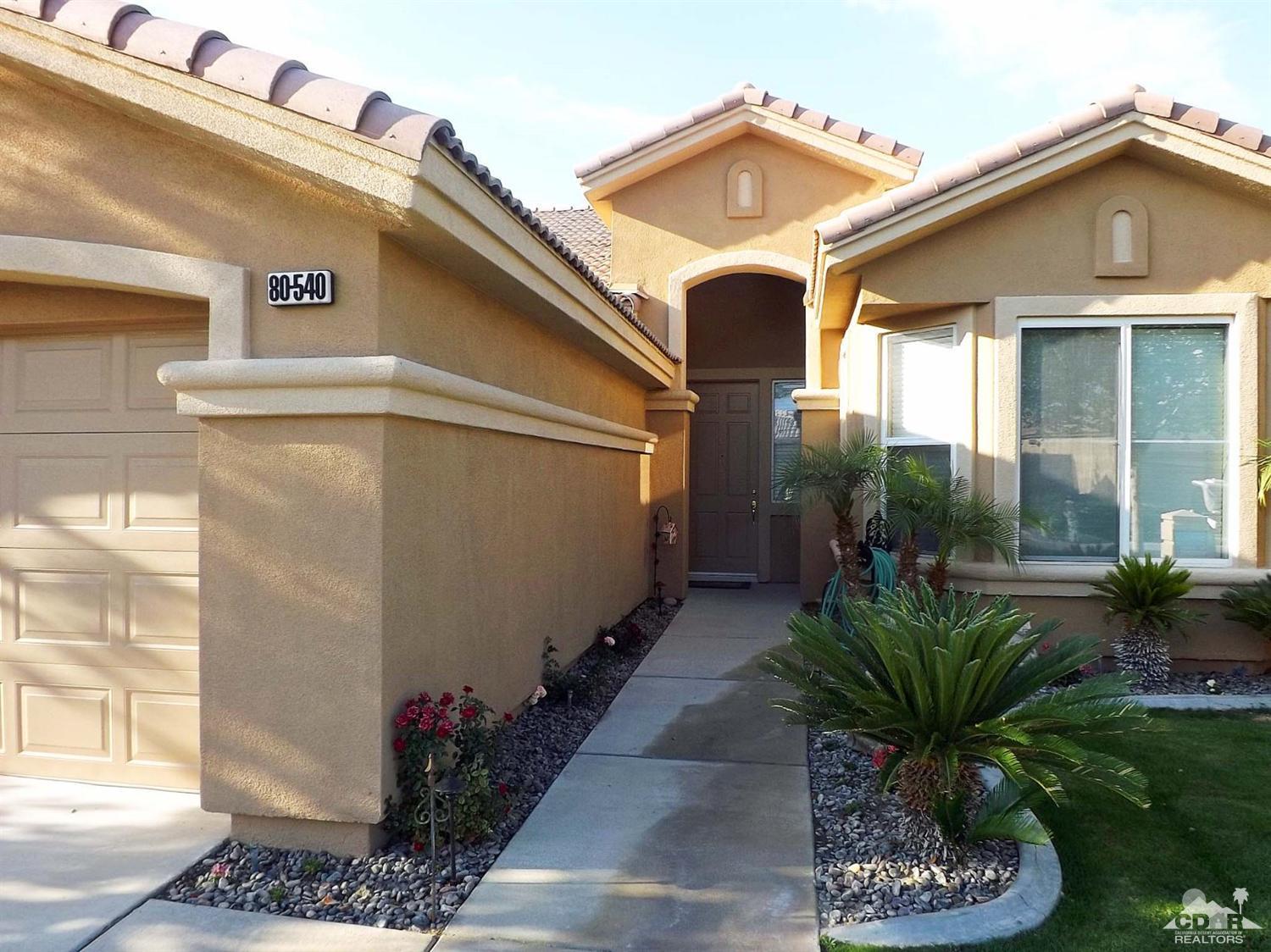 80540 Knightswood Road Indio, CA 92201 - Photo 2 of 34 a view of a house with a small yard and plants
