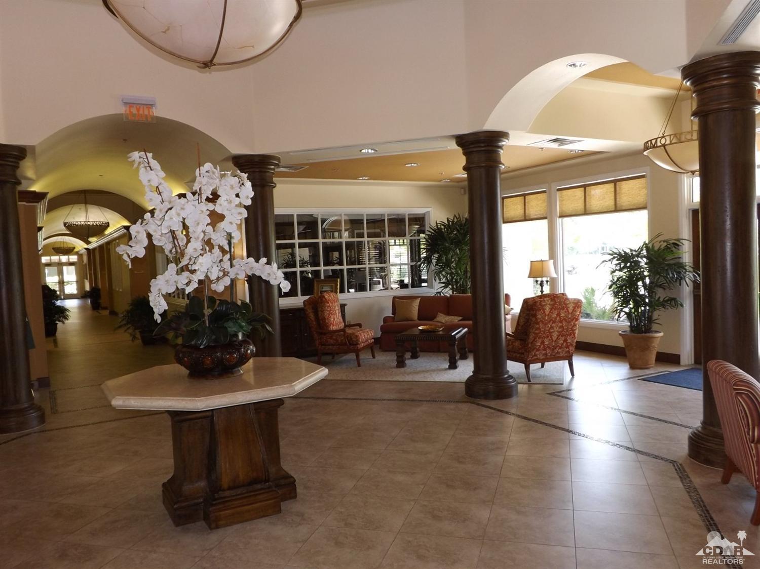 80540 Knightswood Road Indio, CA 92201 - Photo 30 of 34 a living room with fireplace furniture and a floor to ceiling window