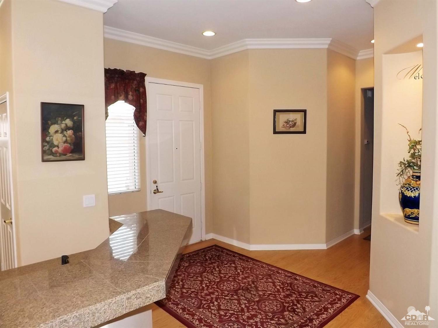 80540 Knightswood Road Indio, CA 92201 - Photo 5 of 34 a view of a livingroom with wooden floor and a rug