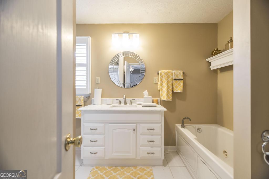 209 Spillers Street Fort Valley, GA 31030 - Photo 17 of 36 a bathroom with a tub sink and mirror