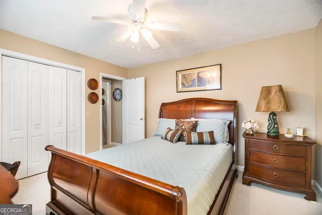 a bedroom with a bed and a lamp