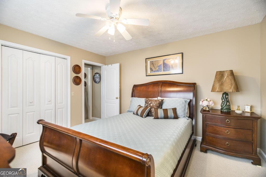 209 Spillers Street Fort Valley, GA 31030 - Photo 19 of 36 a bedroom with a bed and a chandelier