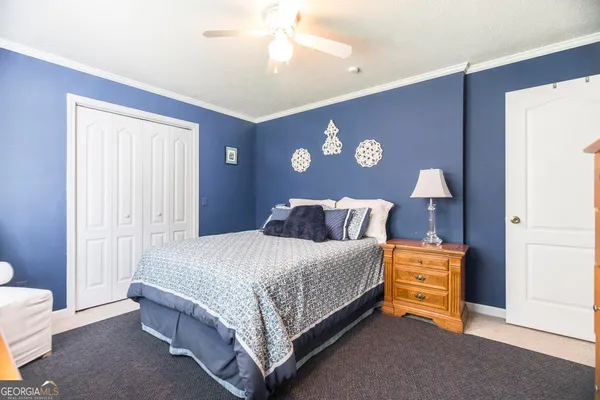 a bedroom with a bed and dresser