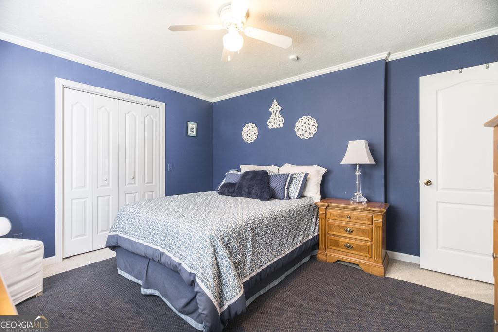 209 Spillers Street Fort Valley, GA 31030 - Photo 20 of 36 a bedroom with a bed and a lamp