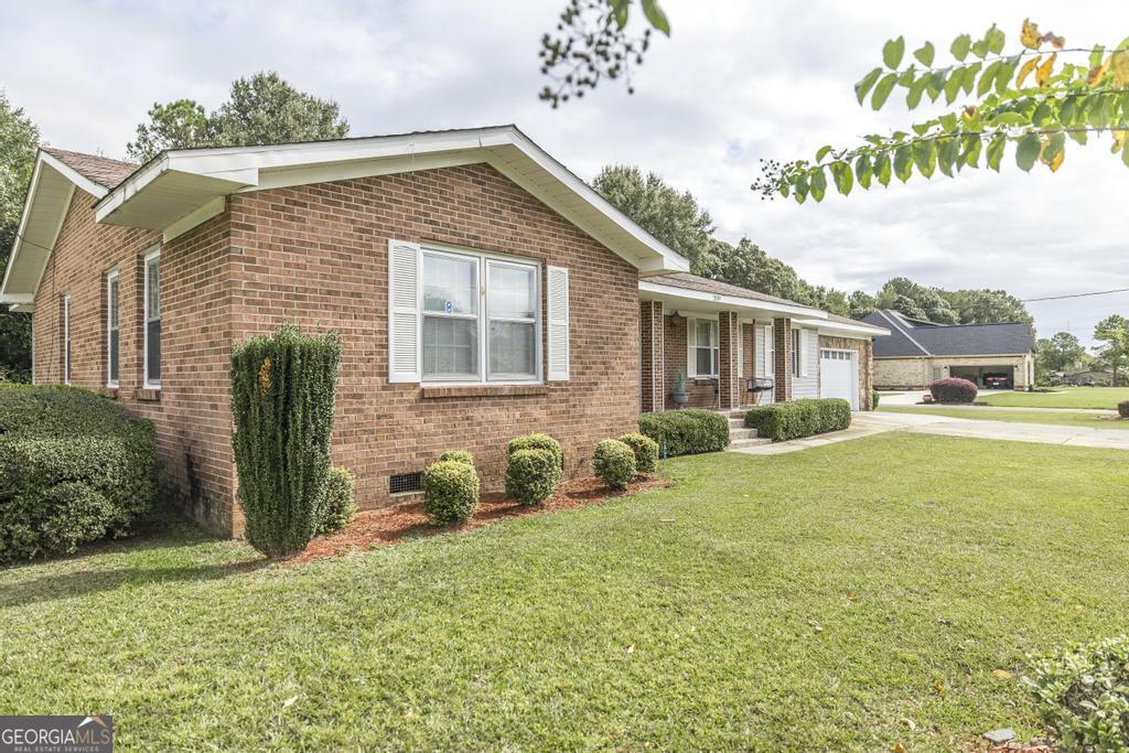 209 Spillers Street Fort Valley, GA 31030 - Photo 2 of 36 a front view of a house with garden