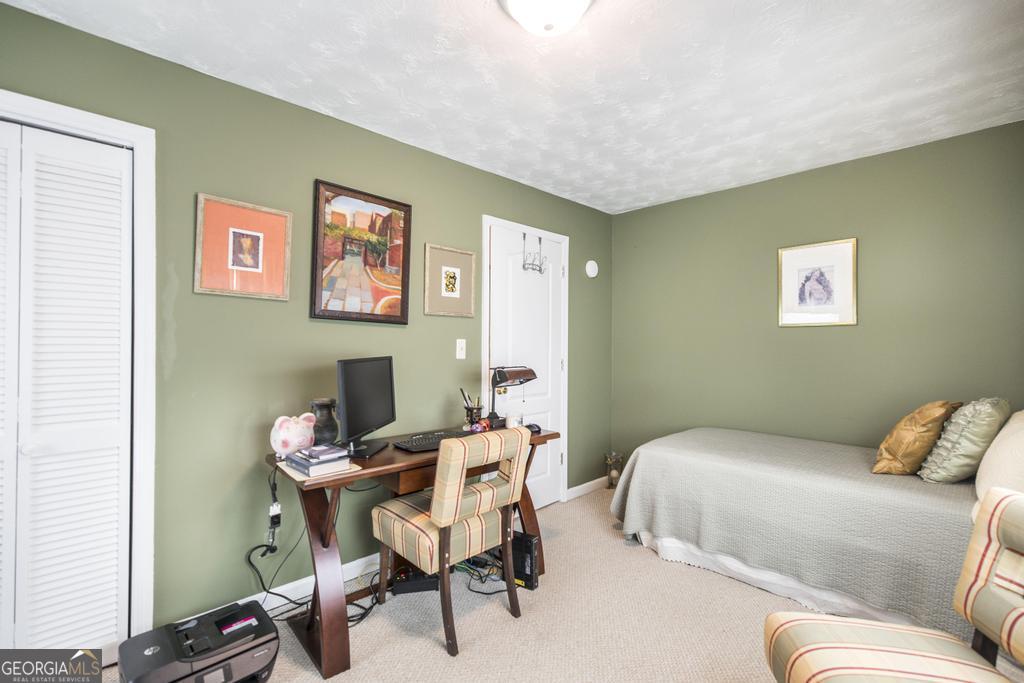 209 Spillers Street Fort Valley, GA 31030 - Photo 23 of 36 a bedroom with a bed and a desk