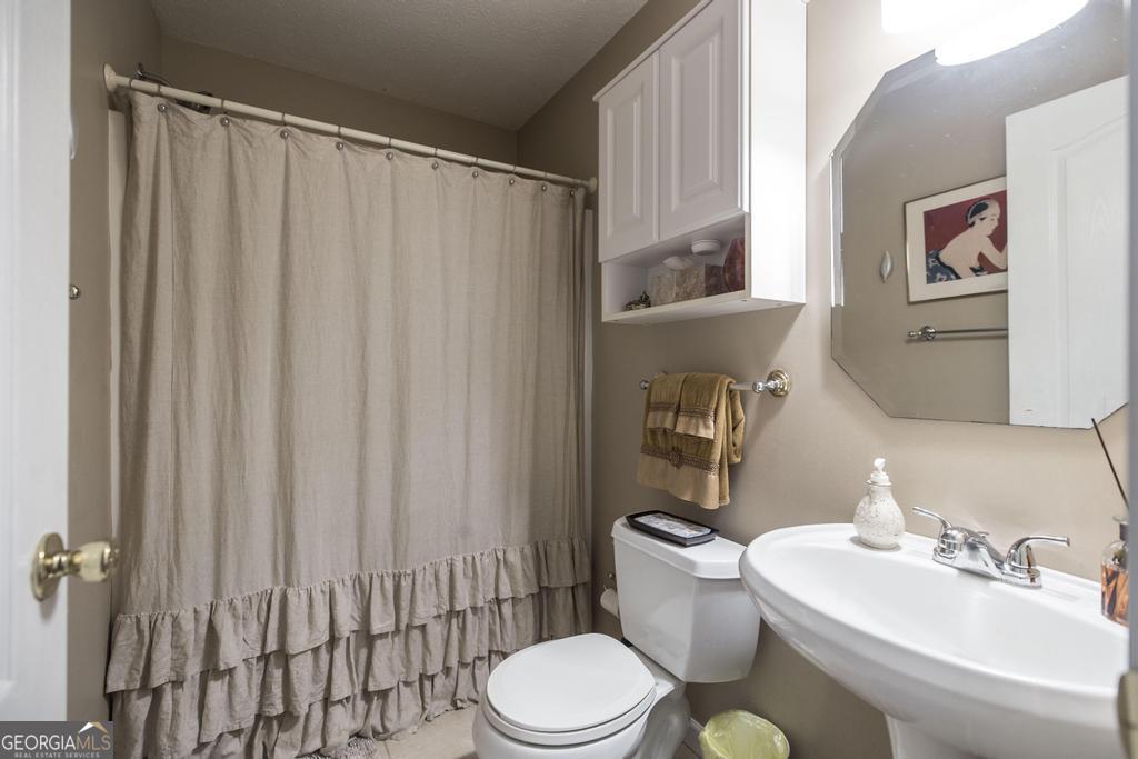209 Spillers Street Fort Valley, GA 31030 - Photo 26 of 36 a bathroom with a sink toilet and shower
