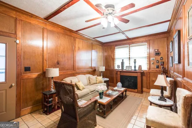 a living room with furniture and a ceiling fan