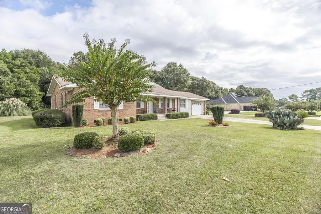 209 Spillers Street Fort Valley, GA 31030 - Photo 31 of 36 a front view of a house with garden