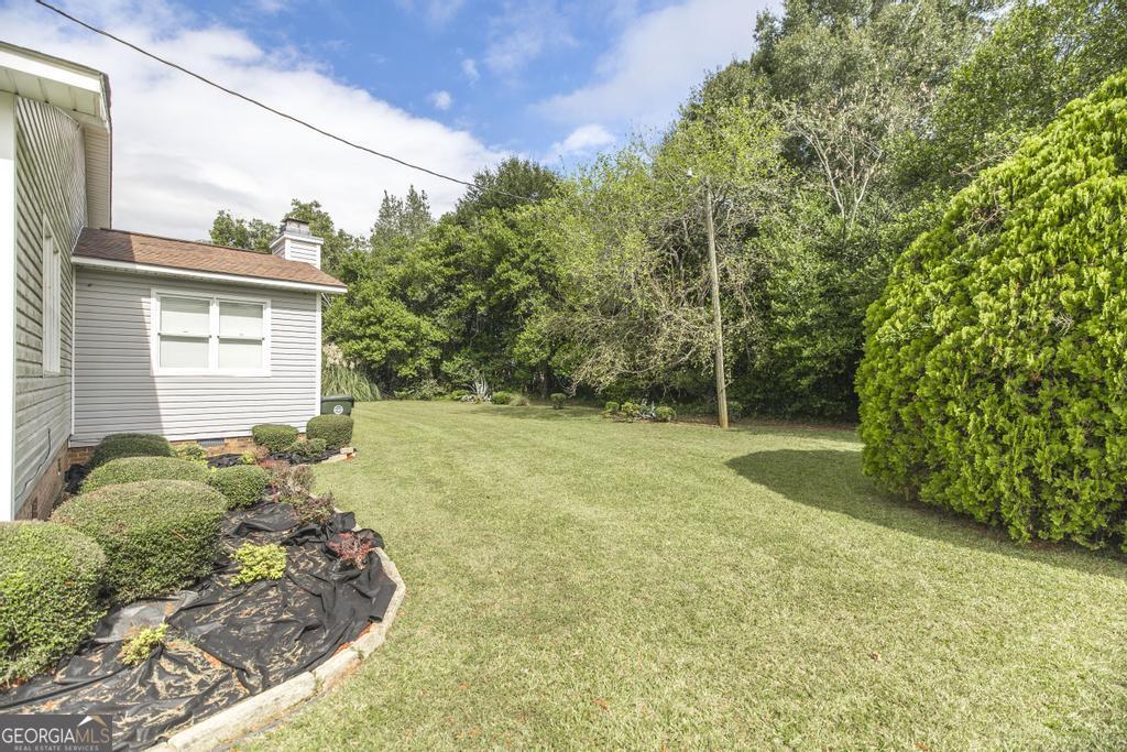 209 Spillers Street Fort Valley, GA 31030 - Photo 36 of 36 a view of a backyard with potted plants
