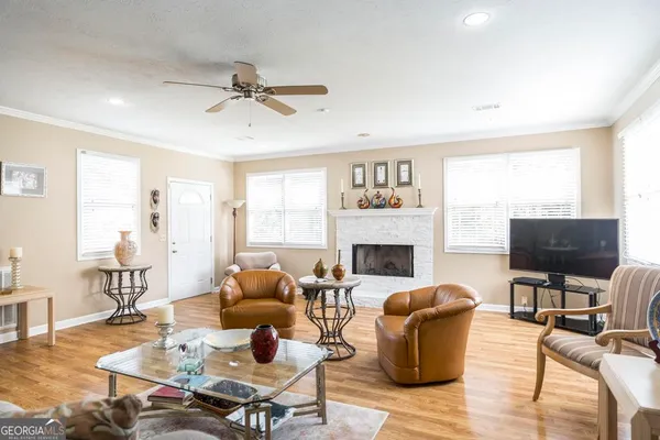 a living room with furniture a fireplace and a flat screen tv