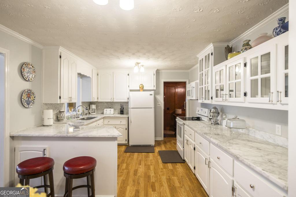 209 Spillers Street Fort Valley, GA 31030 - Photo 9 of 36 a large kitchen with stainless steel appliances granite countertop a sink and a refrigerator