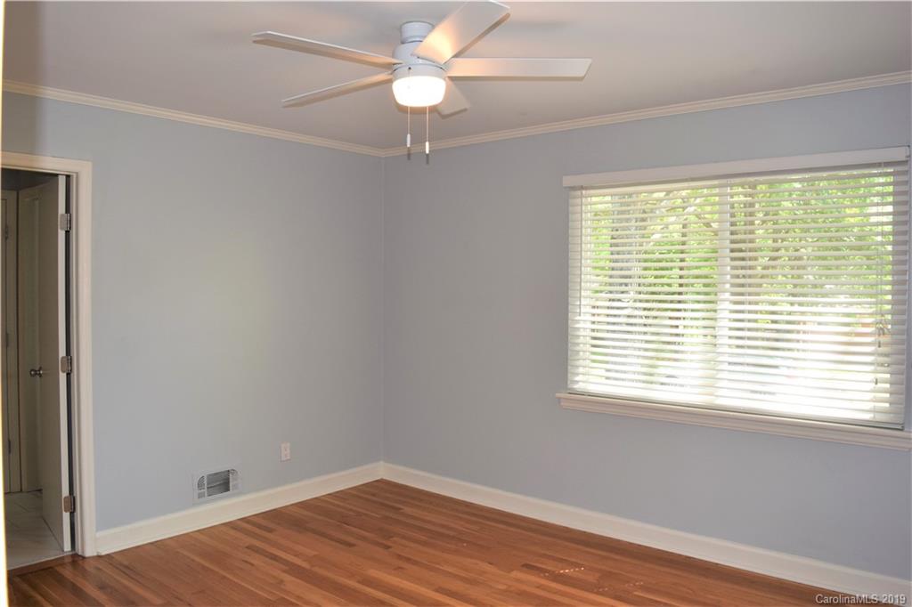 4446 Applegate Road Charlotte, NC 28209 - Photo 14 of 25 a view of an empty room with wooden floor and a window
