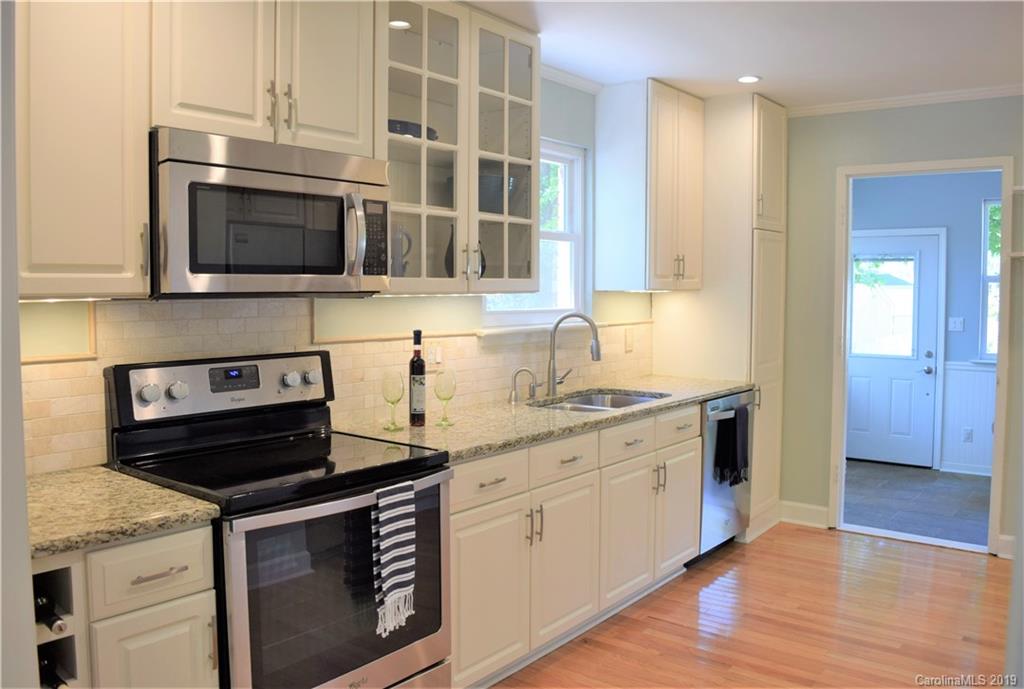 4446 Applegate Road Charlotte, NC 28209 - Photo 8 of 25 a kitchen with stainless steel appliances granite countertop a stove and a microwave