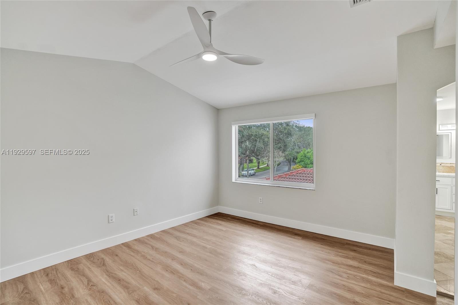 4120 Fern Forest Road Cooper City, FL 33026 - Photo 18 of 44 an empty room with wooden floor and windows