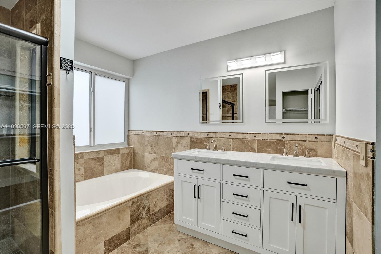 4120 Fern Forest Road Cooper City, FL 33026 - Photo 21 of 44 a bathroom with a granite countertop sink mirror and bathtub