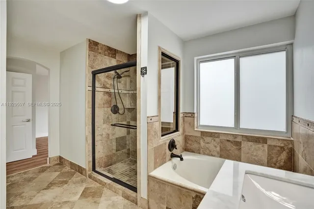 a bathroom with a tub and a sink