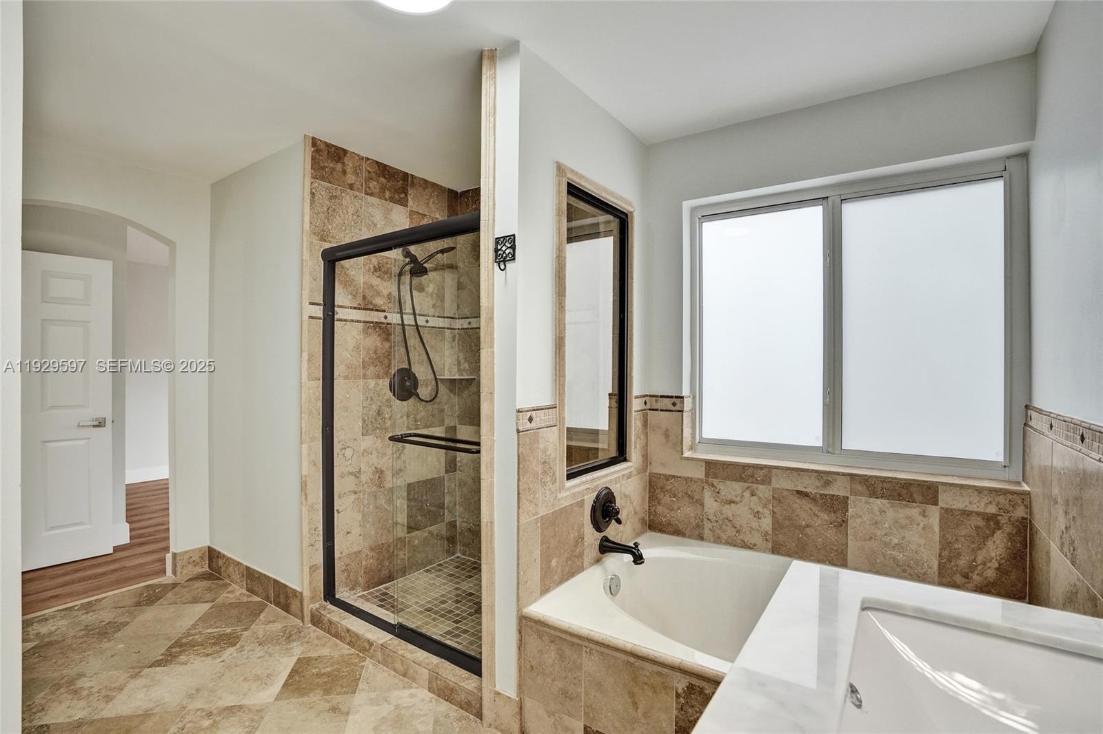 4120 Fern Forest Road Cooper City, FL 33026 - Photo 22 of 44 a bathroom with a tub and a sink