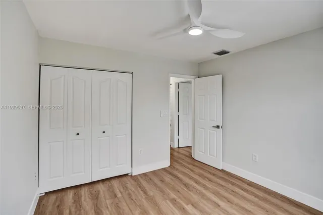 a view of an empty room and wooden floor