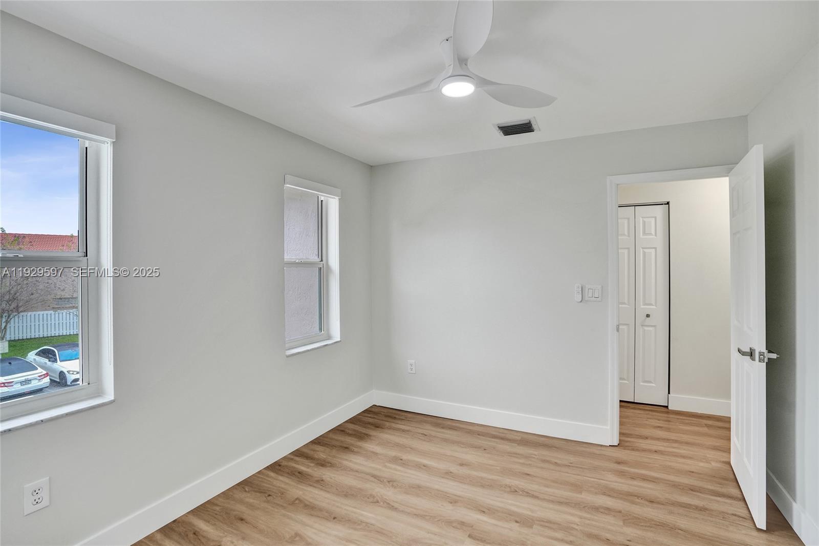 4120 Fern Forest Road Cooper City, FL 33026 - Photo 29 of 44 a view of an empty room with wooden floor and a window