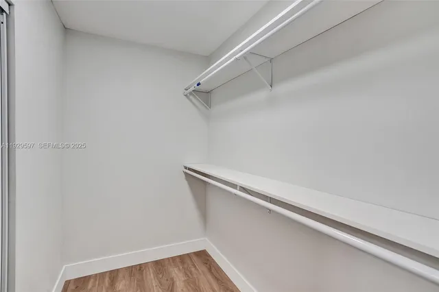 a view of walk in closet with empty racks