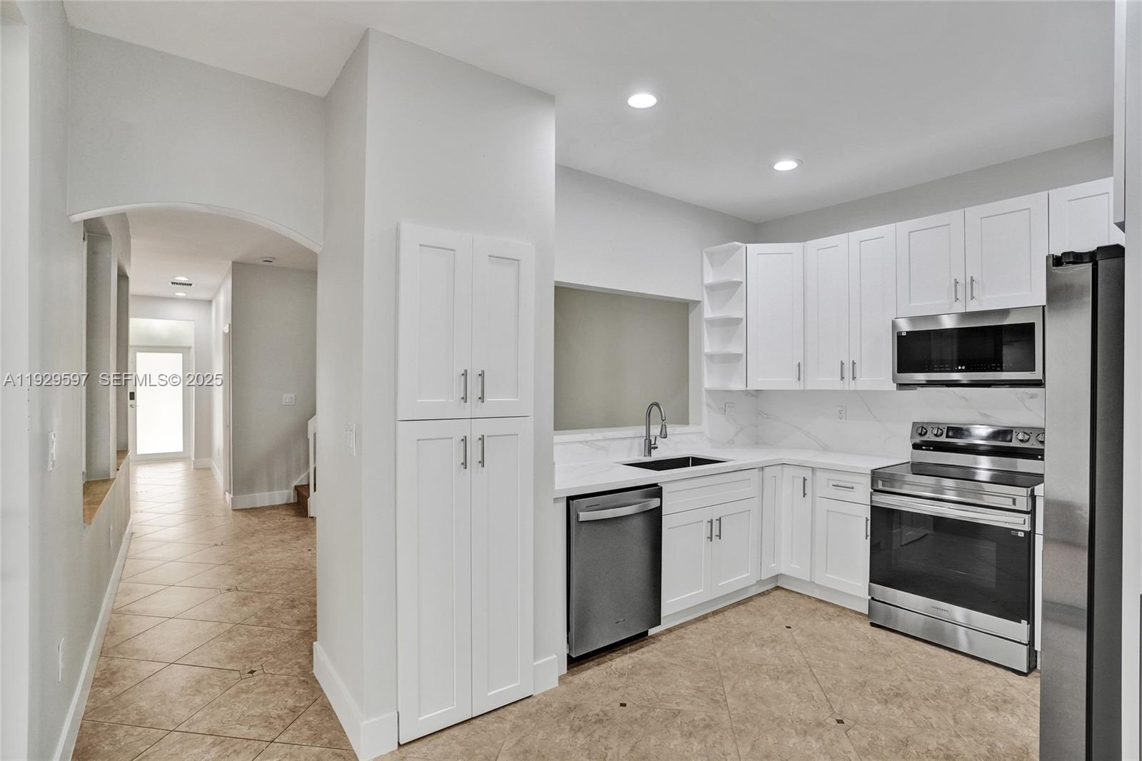 4120 Fern Forest Road Cooper City, FL 33026 - Photo 6 of 44 a kitchen with stainless steel appliances a stove sink and refrigerator