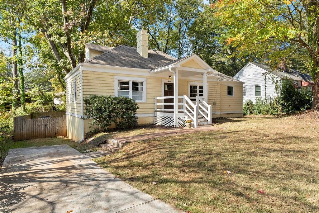 1861 Sylvan Road Southwest Atlanta, GA 30310 - Photo 1 of 1 a view of a white house with a yard and large trees
