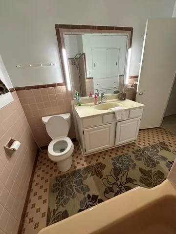 a bathroom with a sink a toilet and mirror